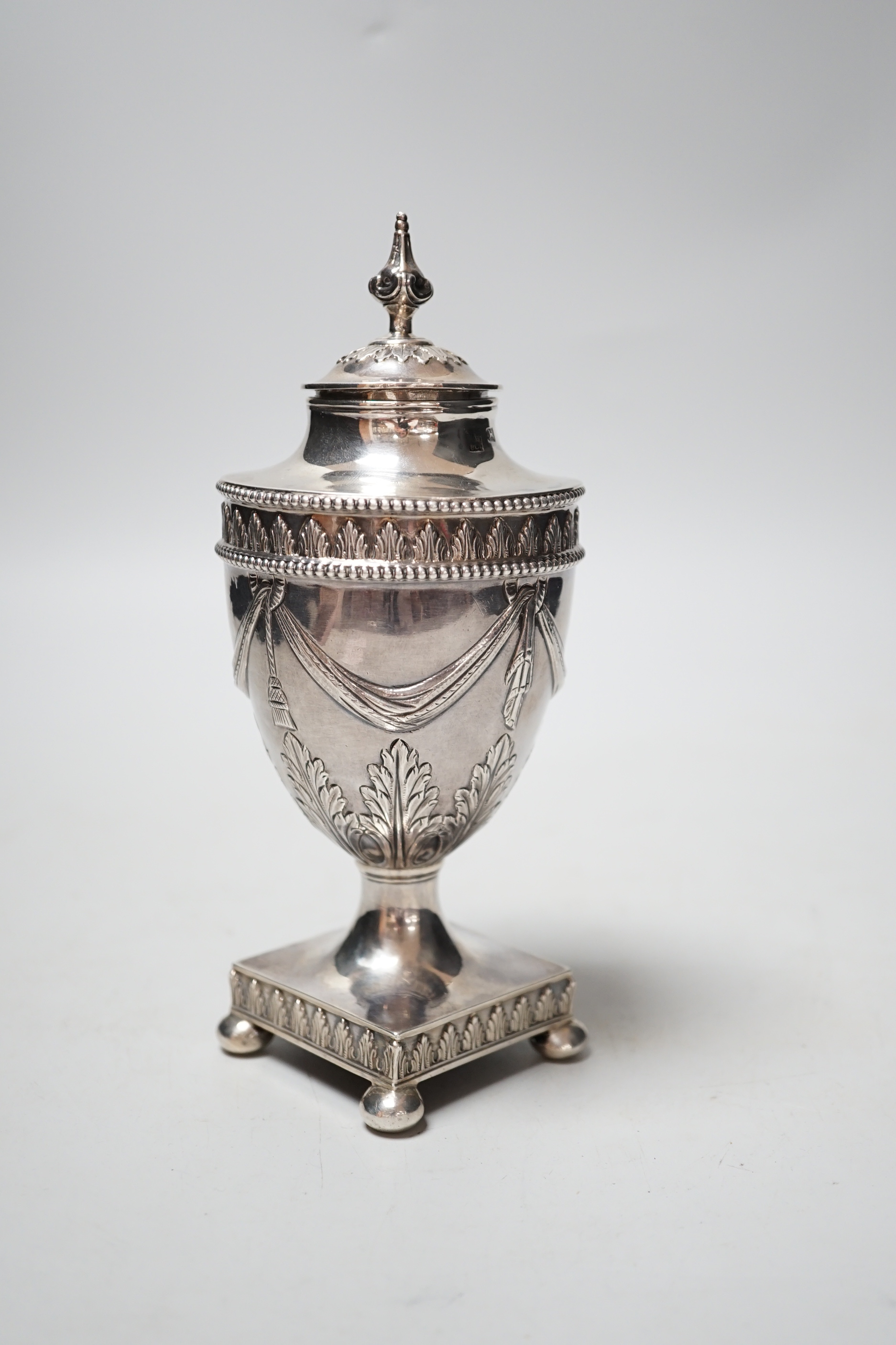 A George III silver vase and cover, with swag and fern decoration, on square base, with ball feet, Richard Morton & Co, Sheffield, 1775, 18cm, 8.7oz.